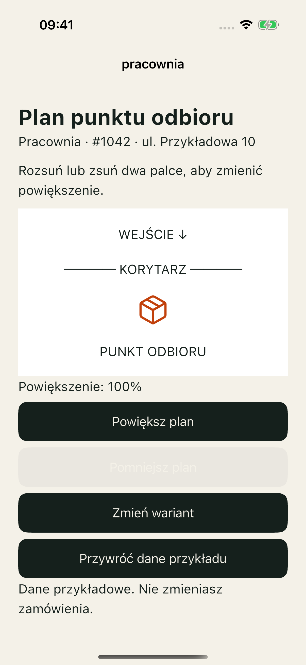 iOS Simulator, dobra demonstracja Pracowni: plan punktu odbioru, skala 100% oraz nazwane przyciski powiększania i pomniejszania.